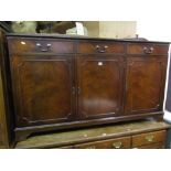 A reproduction Georgian style mahogany side cupboard enclosed by three moulded panelled doors