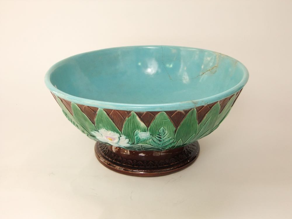 A 19th century majolica punch bowl by Joseph Holcroft with moulded and painted water lily and fern