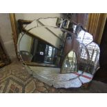 An early 20th century frameless wall mirror of oval form with bevelled edge plate and simulated