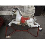 A vintage Mobo prairie king child's toy galloping horse raised on a painted tubular steel stand