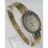 Marcel Drucker ladies gold plated cocktail type watch the bezel fitted with ten diamonds, within