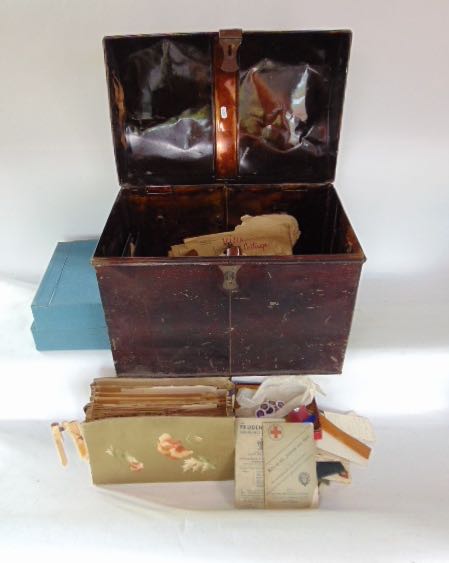 A tin trunk containing various miscellaneous items to include letters and other works on paper.