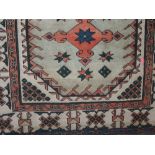 Afghan type floor rug decorated with orange medallions and stars upon a cream ground, 210 x 135cm