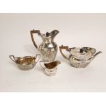 Late 19th century silver four piece bow shaped half fluted tea service, maker Walter J Barnard,