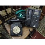 A vintage telephone with black colourway and circular dial, one other and a more contemporary coin