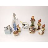 A collection of four Hummel figures of children, two Beswick Beatrix Potter figures of Mr Benjamin