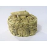 A 19th century Japanese ivory box and cover decorated with multiple carved faces, 6 cm