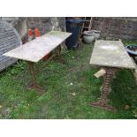 A pair of weathered cast iron refectory style pub tables of rectangular form with decorative