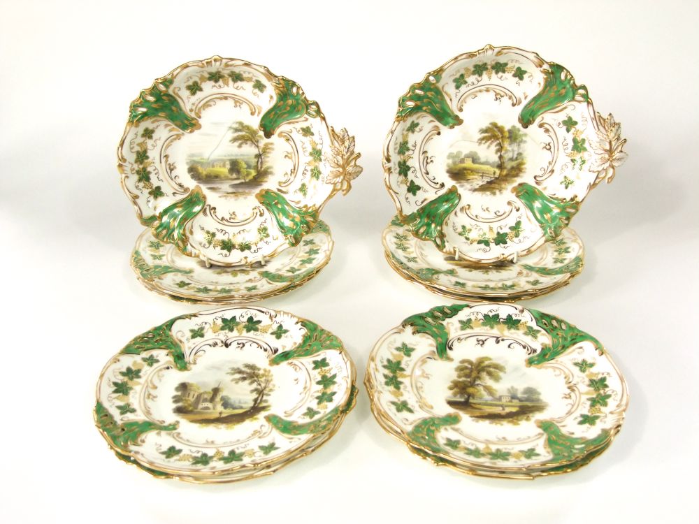 A good quality 19th century dessert service with central painted landscape panels within green and