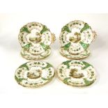 A good quality 19th century dessert service with central painted landscape panels within green and