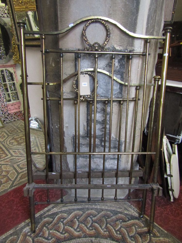 A single brass bedstead with square cut rails beneath mushroom finial's