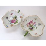 A pair of 19th century continental leaf shaped dishes with polychrome painted decoration to the