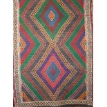 Suzmi Kelim runner decorated with colourful diamond shaped pattern upon a brown ground, 170 x 57cm