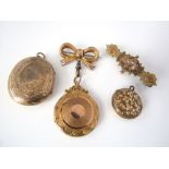 A gold locket suspended from a 9ct bow brooch, together with a 9ct floral brooch and two further