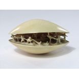 19th century Japanese ivory clam shell, the interior carved with fisherman, nets, boat, etc, 9 cm