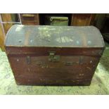 A vintage brown fibre and leather reinforced domed top travelling chest with brass lock and army and