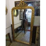 A large contemporary reproduction wall mirror in the 19th century style, the bevelled edge plate set