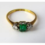 An emerald and diamond three stone ring in 18ct gold, size K, 1.5g