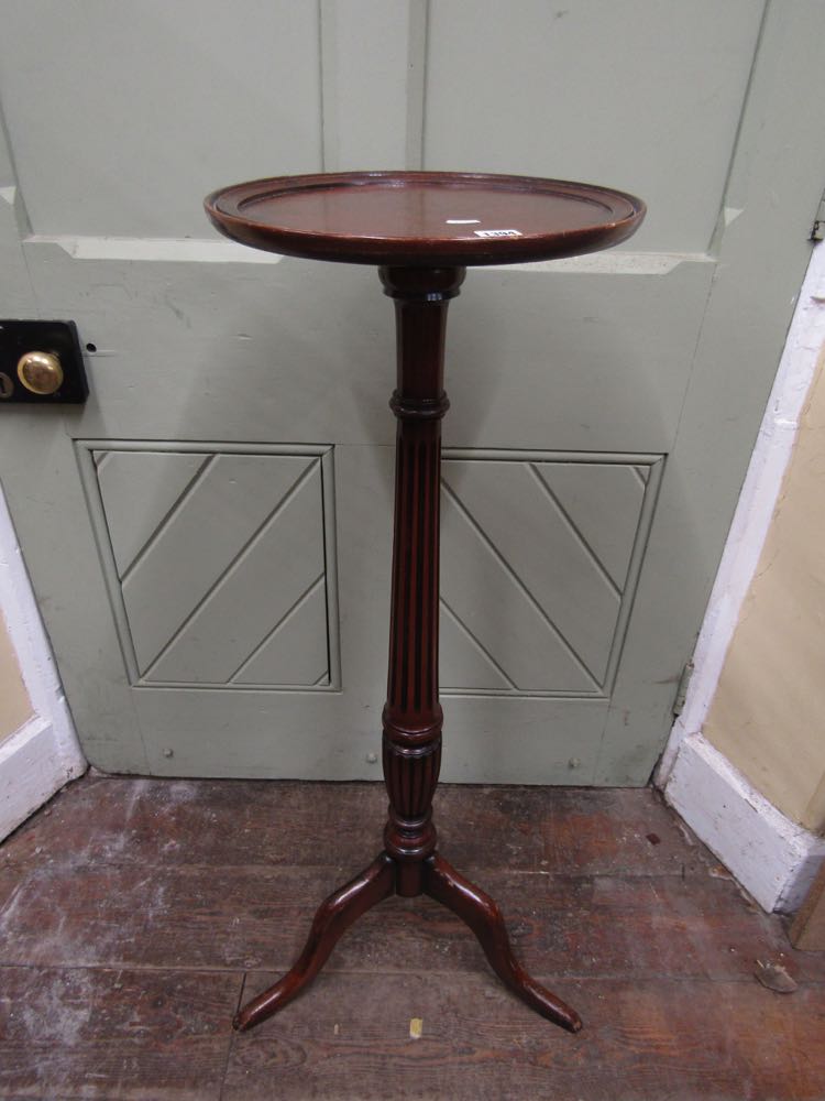 A Georgian style torchere, the circular dish top raised on a fluted pillar and shaped tripod