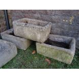 Three weathered composition stone clad planters/troughs of rectangular form, each approx 25 inches x