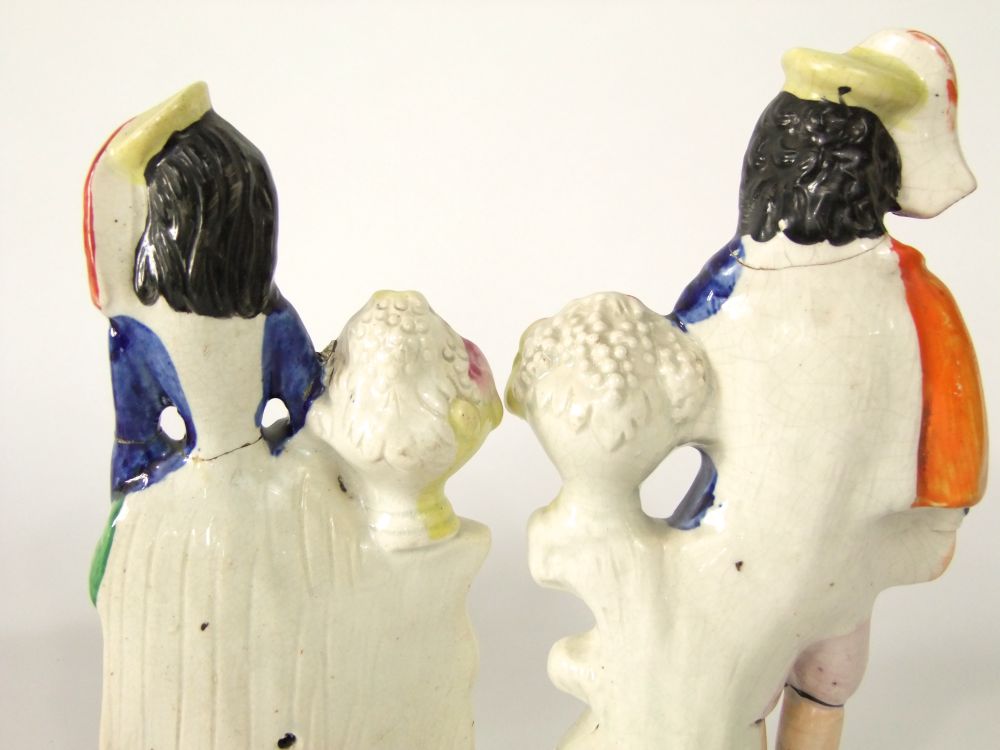 A pair of 19th century Staffordshire figures of male and female musicians accompanied by dogs, - Image 3 of 7