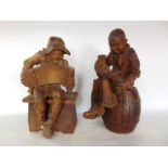 A pair of Black Forest type carved oak figures of tavern characters to include a drunk on a beer