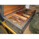 A vintage stained pine carpenters chest with hinged lid, enclosing a segmented tray interior