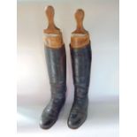 A pair of gentleman's leather riding boots with stretchers.