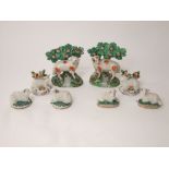 A pair of early 19th century Staffordshire type models of sheep with bocage together with two