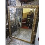 A large contemporary wall mirror of rectangular form with bevelled edge plate within a gilt