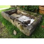 A shallow weathered composition stone clad planter/trough of rectangular form, 27 inches x 23 inches