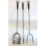 Three good quality polished steel arts and crafts fire irons