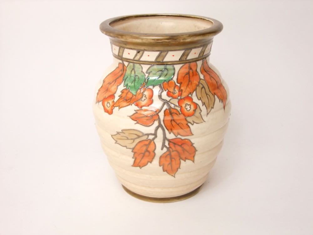 A Crown Ducal vase of ribbed moulded form designed by Charlotte Rhead with painted autumn leaf