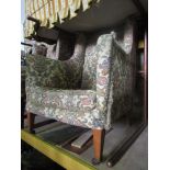 An Edwardian wing chair with floral tapestry detail