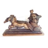 Plaster sculpture of a Roman chariot scene upon a wooden plinth base, 74cm long