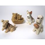 A collection of Sylvac figures of dogs including a humorous stylised model of a seated spaniel