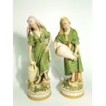 A pair of large early 20th century Royal Dux figures of male and female water carriers, both in