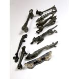 An unusual collection of ten pewter knife rests in the form of stretched animals, squirrel,