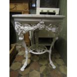 a Victorian cast iron circular pub table with rams mask detail and later white marble top