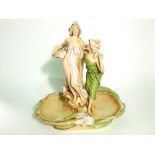 An early 20th century Royal Dux table centre piece with applied figures of female characters