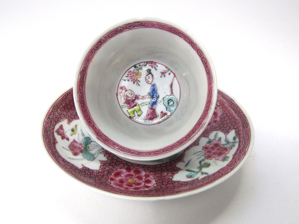 A 19th century Chinese eggshell porcelain tea bowl and saucer with famille rose floral figural