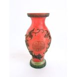 Interesting Chinese red glass baluster vase, centrally fitted with medallions and framed by mythical