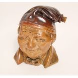 A large 19th century salt glazed novelty flask modelled as Jonny Souter wearing a bow tie and