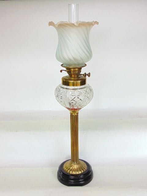 An impressive large brass and cut glass oil lamp with opaque lobed glass shade over a star cut glass