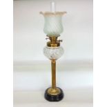 An impressive large brass and cut glass oil lamp with opaque lobed glass shade over a star cut glass