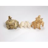 A Chinese ivory carving of an elephant and master, a further ceremonial elephant and master and