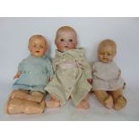 An Armand Marseilles German bisque headed baby doll with closing eyes and open mouth with two bottom