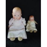 Two Armand Marseille bisque headed baby dolls, both with closing eyes, open mouth revealing two