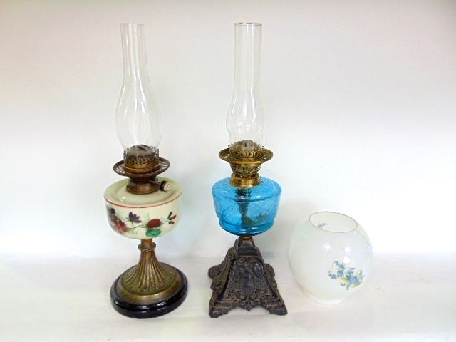 A Victorian brass and opaline glass oil lamp with opaque glass shade with floral overlay, 50 cm high