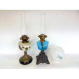 A Victorian brass and opaline glass oil lamp with opaque glass shade with floral overlay, 50 cm high